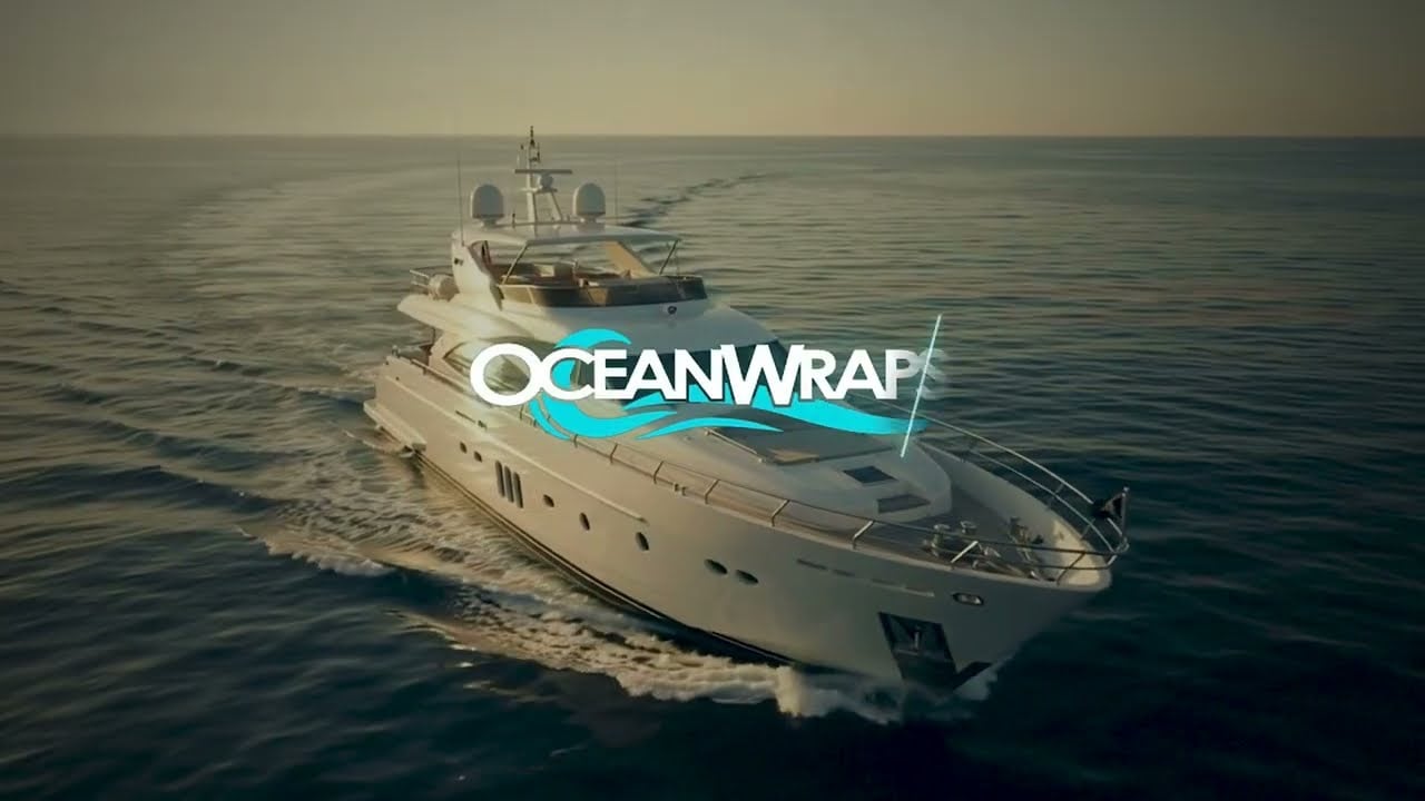 Ocean Wraps yacht cruising offshore at sunset
